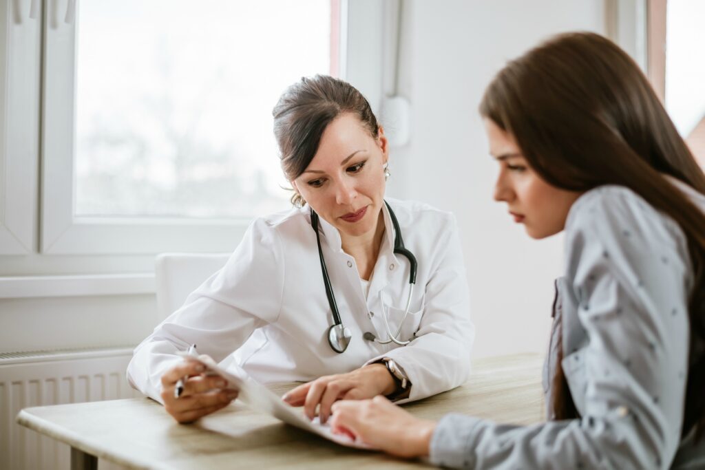 Uma jovem se consultando com uma médica antes de viajar