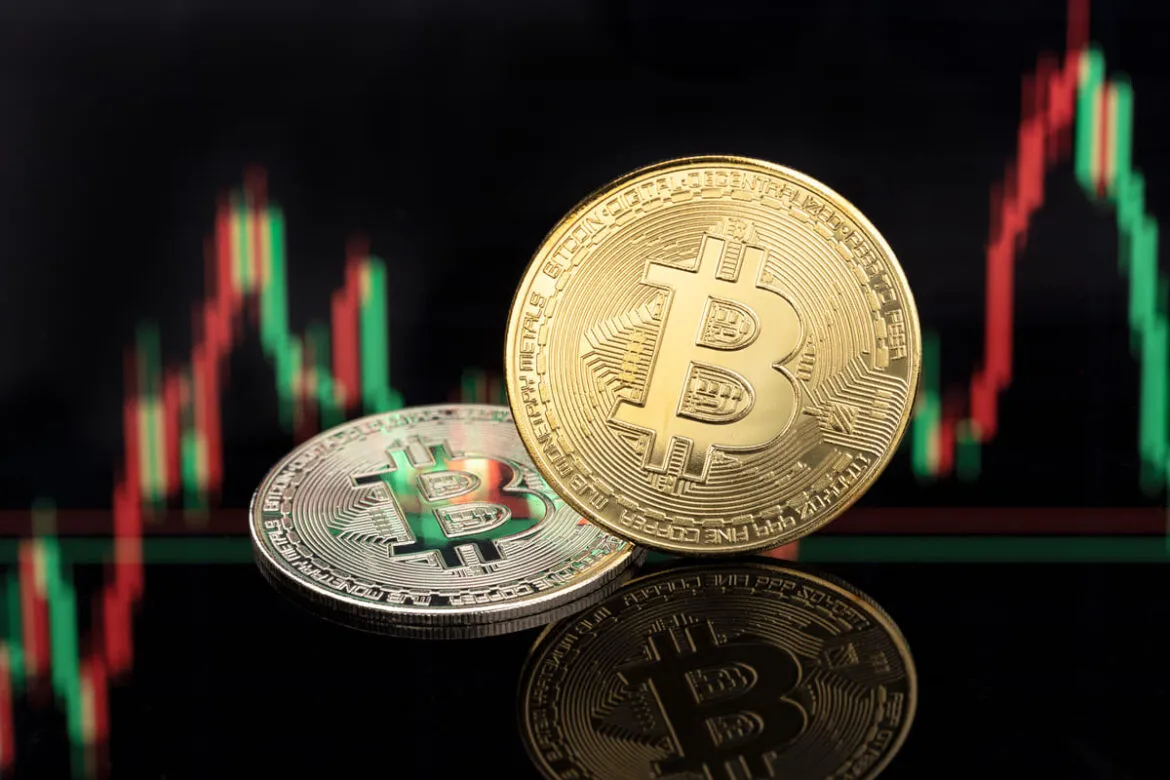 Duas moedas de Bitcoin com um fundo de gráficos financeiros de bolsa de valores para ilustrar um texto sobre ETF Bitcoin.
