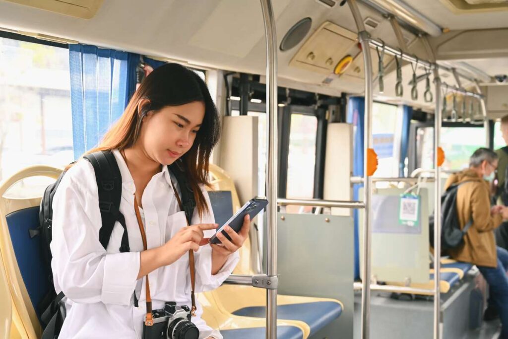 Jovem comprando passagens pela Flixbus na Europa pelo smartphone.