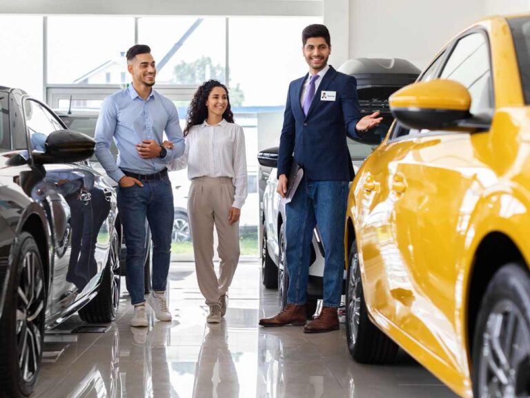 Casal com vendedor prontos para comprar carro nos EUA