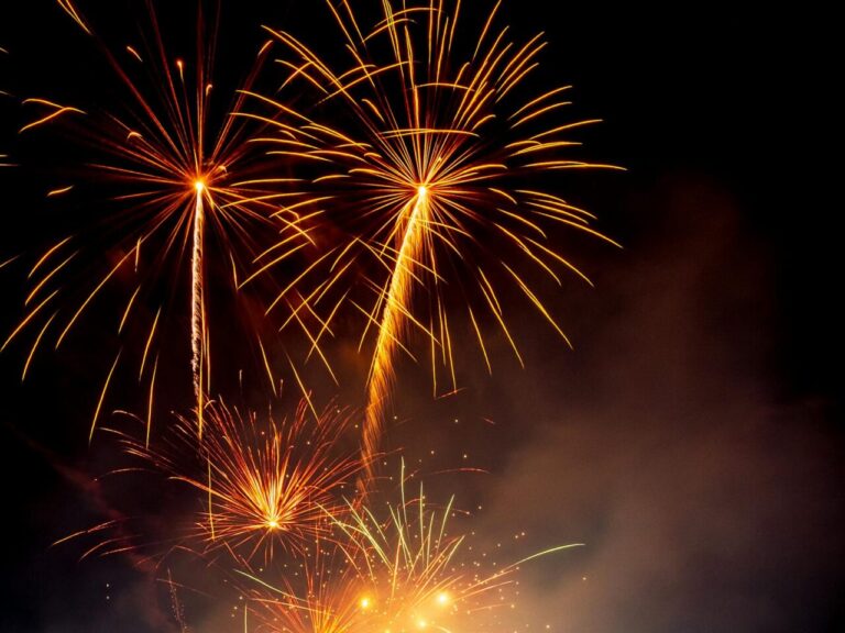 A stunning display of colorful fireworks illuminating the night sky at a lively celebration.