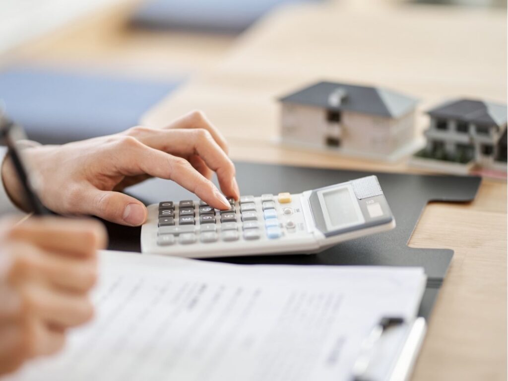 Homem calculando as taxas de como financiar uma casa pela Caixa